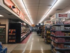 an empty grocery store aisle with food on the shelves and other items in the aisles