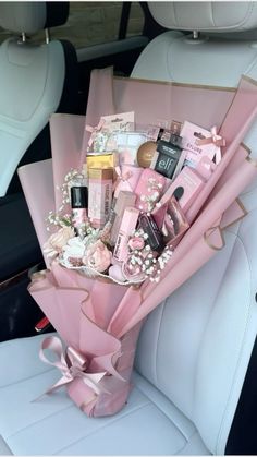 a bouquet in the back seat of a car filled with cosmetics and personal care items