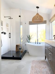 a bathroom with a large bathtub next to a window