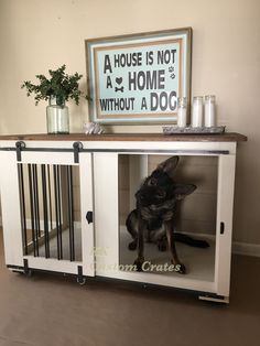 a dog is sitting in its kennel and looking at the camera with his paw on the door