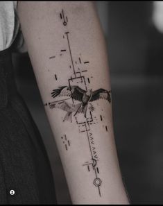 a tattoo on the arm of a woman with a bird flying over it and an arrow