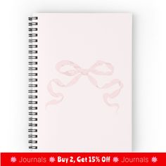 a spiral notebook with pink ribbon on it and the words journals 2 get 15 % off