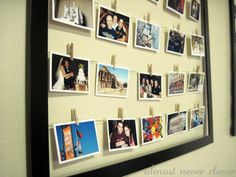 a wall with pictures hanging on it and clothes pins attached to the pegs that hold photos