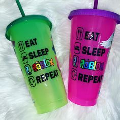 two plastic cups with straws sitting on top of a white furnishing floor