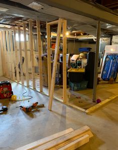 an unfinished room with wood framing and tools on the floor