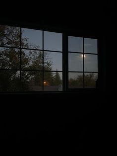 the window is open and there are no people outside in the dark room at night