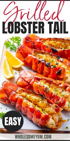 grilled lobster tail with lemon wedges and parsley on the side