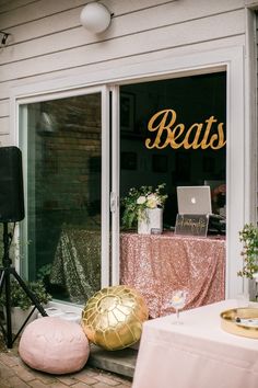 there is a pink and gold decoration in front of the store's window display