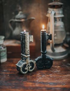 two candles sitting on top of a wooden table