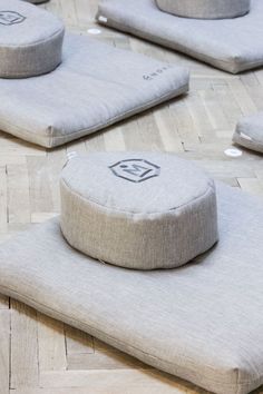 four round cushions sitting on top of each other in the middle of a flooring area