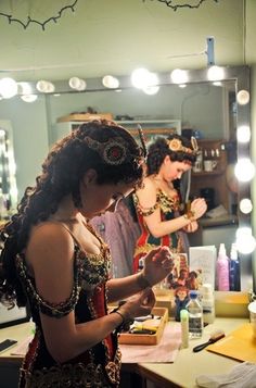 a woman is standing in front of a mirror