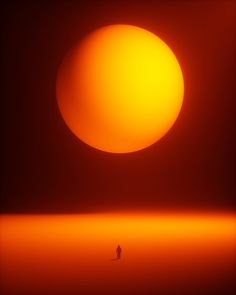 a person standing in front of the sun with an orange glow on it's face