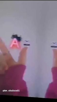 two people holding up their cell phones in front of the camera with one person's hands