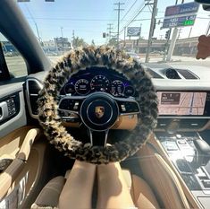 the interior of a car with a steering wheel covered in faux fur and furry trim