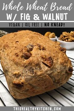 a loaf of whole wheat bread sitting on top of a cooling rack with walnuts