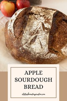 an apple sourdough bread on a table with apples in the background and text overlay that reads, apple sourdough bread