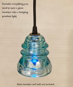 a glass hanging light with an inspirational quote on the bottom and below that reads,