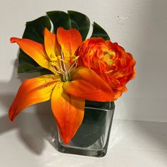 an orange flower is in a square vase with the price $ 20 on this postcard