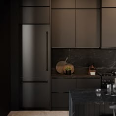 a black kitchen with marble counter tops and stainless steel appliances