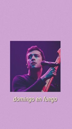 a man holding a microphone in front of a purple background with the words domino en fuego