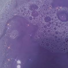 bubbles in water with sparkles on the bottom and purple hued backgroud