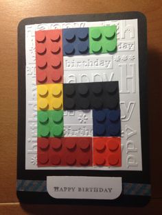 a birthday card made out of legos with the letter e on it's side