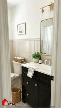 a bathroom with a sink, toilet and mirror in it's centerpieces