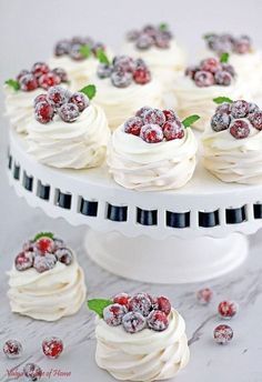 a white cake topped with whipped cream and raspberries