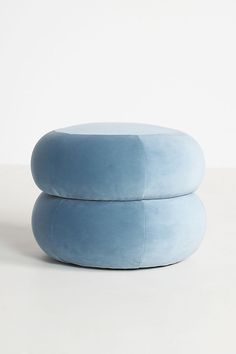 two blue pillows sitting on top of each other