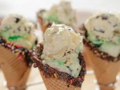 three ice cream cones with sprinkles and chocolate