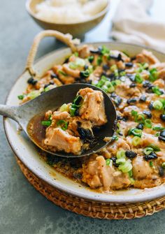 a spoon with some food in it on a plate