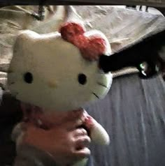 a person holding a hello kitty stuffed animal