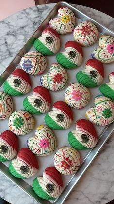 there are many decorated cookies on the tray