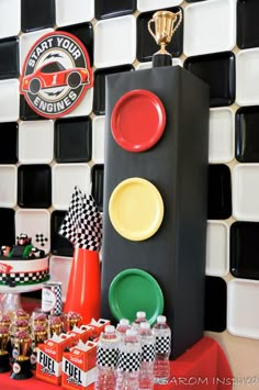 a table topped with plates and cups next to a traffic signal sign on top of a counter