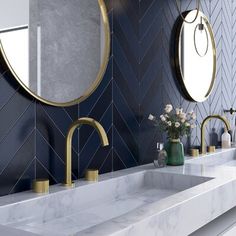 a bathroom with two sinks and mirrors on the wall next to each other in front of a blue tiled wall