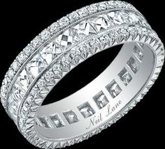 a wedding ring with three rows of princess cut diamonds on the sides and an inscription that says