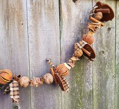 an old fashioned hat and other items are hanging on a wooden fence with the word love spelled out