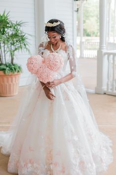 a woman in a wedding dress holding flowers