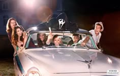 a group of people riding in the back of a car