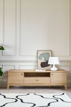 a living room scene with focus on the tv stand and rug in the foreground