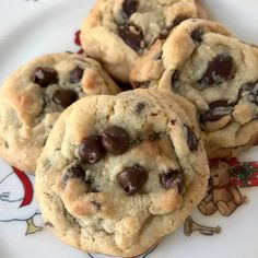 four chocolate chip cookies on a plate