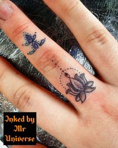 a person with a small tattoo on their ring finger that says inked by mr universe