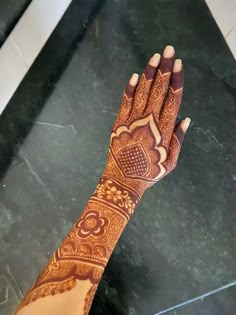 a woman's hand with henna on it