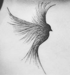 a black and white photo of a bird tattoo