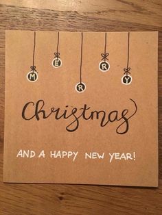 a christmas card with ornaments hanging from strings on a brown background that says, merry and a happy new year