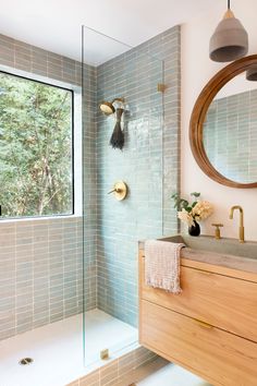 a bathroom with a sink, mirror and shower