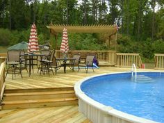 an above ground pool surrounded by wooden decking