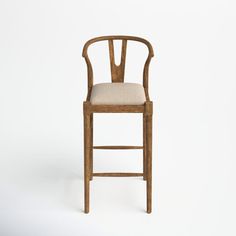 a wooden chair with a beige upholstered seat and backrest, against a white background