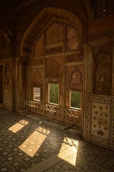 the sun shines through two windows in an ornately decorated room with tile flooring