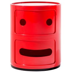 a red two - tiered container with holes on the front and sides, each side has a smiley face painted on it